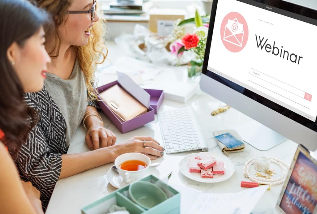 Two women receiving and event email