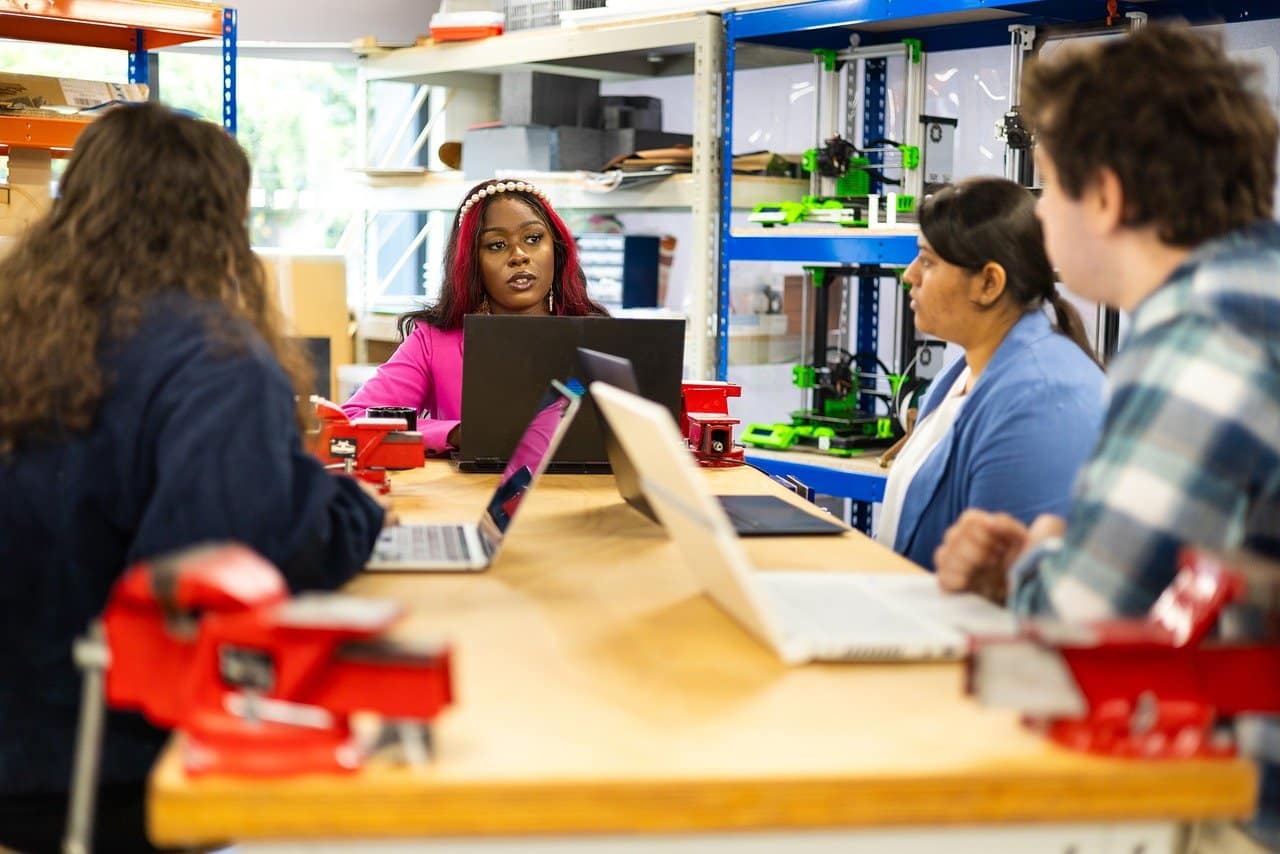 Four people sitting in a team meeting